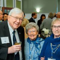 president lubbers smiling with two women